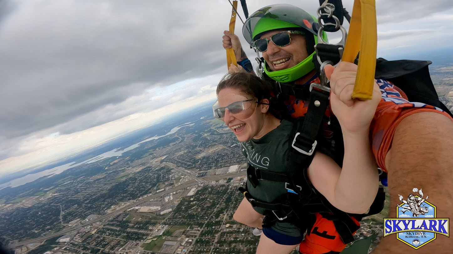 Happy skydivers flying a parachute together, enjoying the thrill of the descent